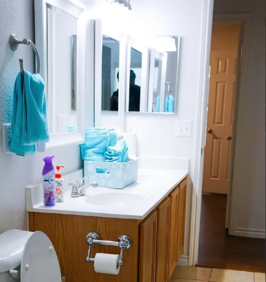 A clean, bright bathroom with a wide vanity and fresh towels