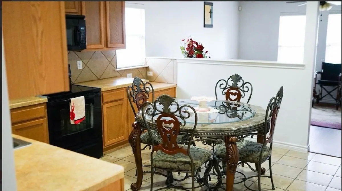 The kitchen at Heritage Touch, with a breakfast table beside the counter