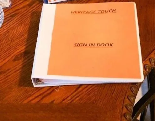 The Heritage Touch sign-in book on the welcome table just inside the front door